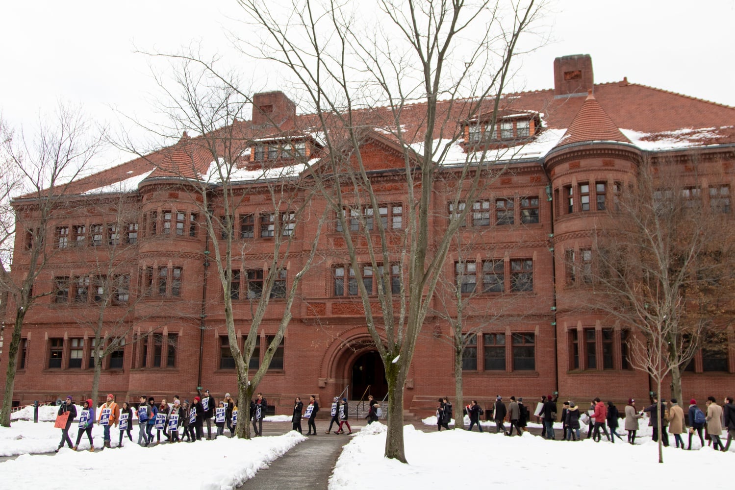 Picketers marched around the yard, passing academic buildings including Sever Hall.