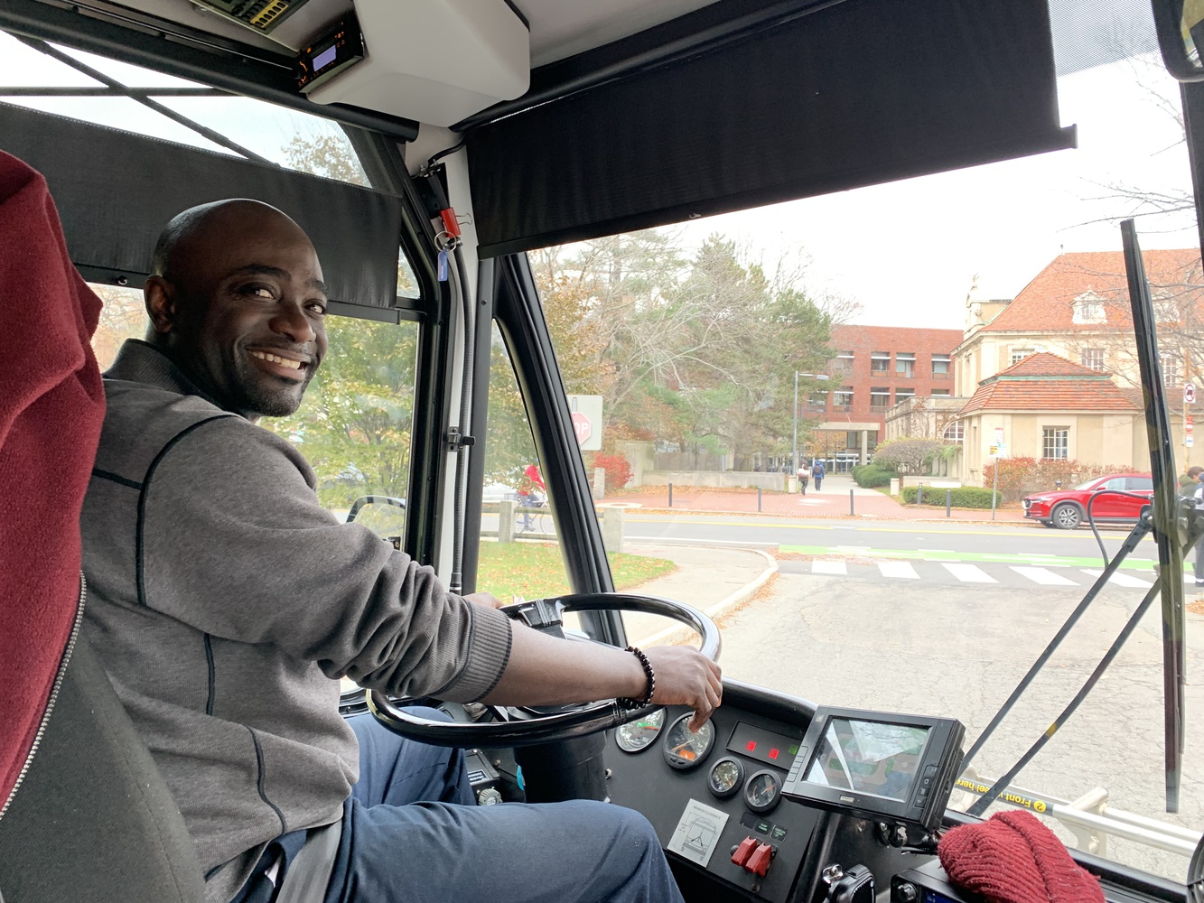 Raymond Quitumba Jr. picks up students on the shuttle.