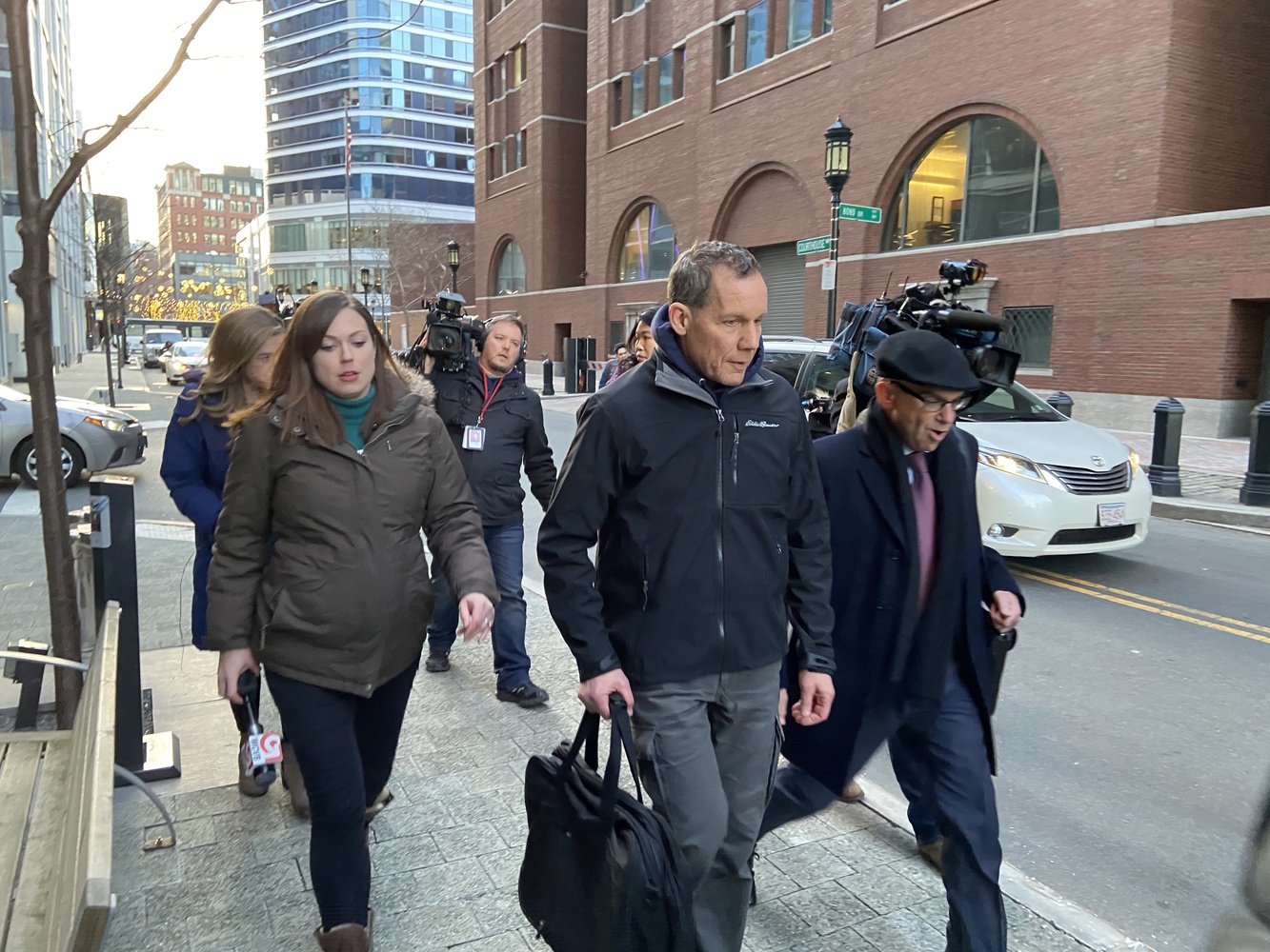 Chemistry professor Charles M. Lieber (center) leaves the John Joseph Moakley Courthouse in Boston after a bail hearing.