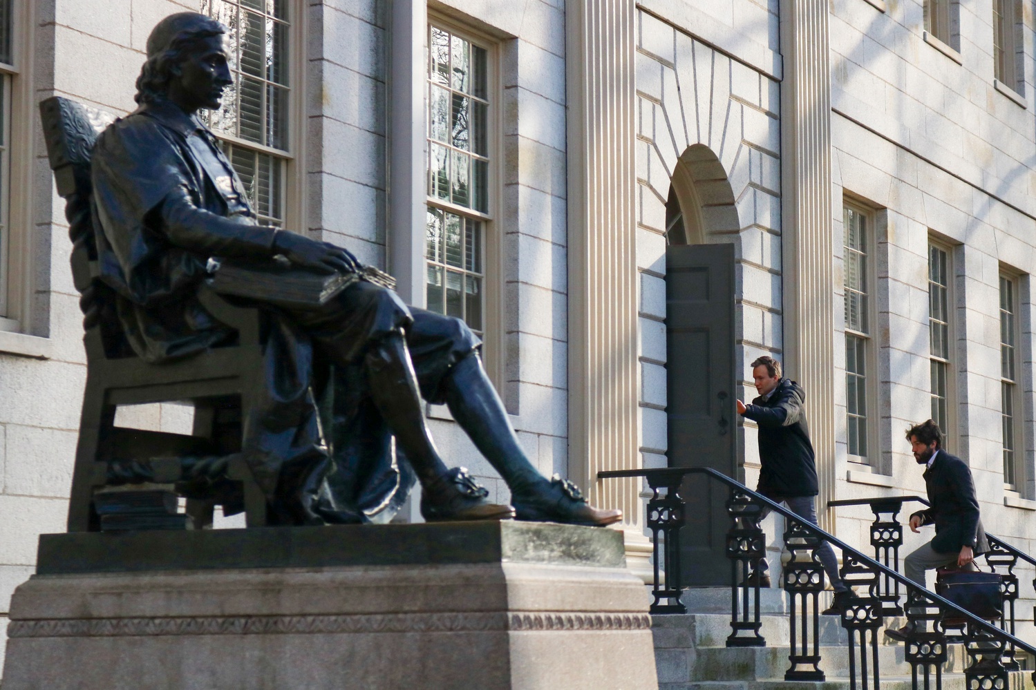 Members of Harvard's faculty walk into University Hall for their monthly meeting Tuesday afternoon.