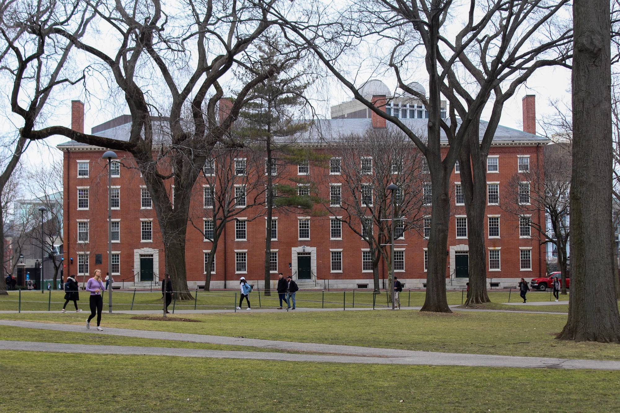 Visitors and students walk along paths through Harvard Yard Tuesday morning.