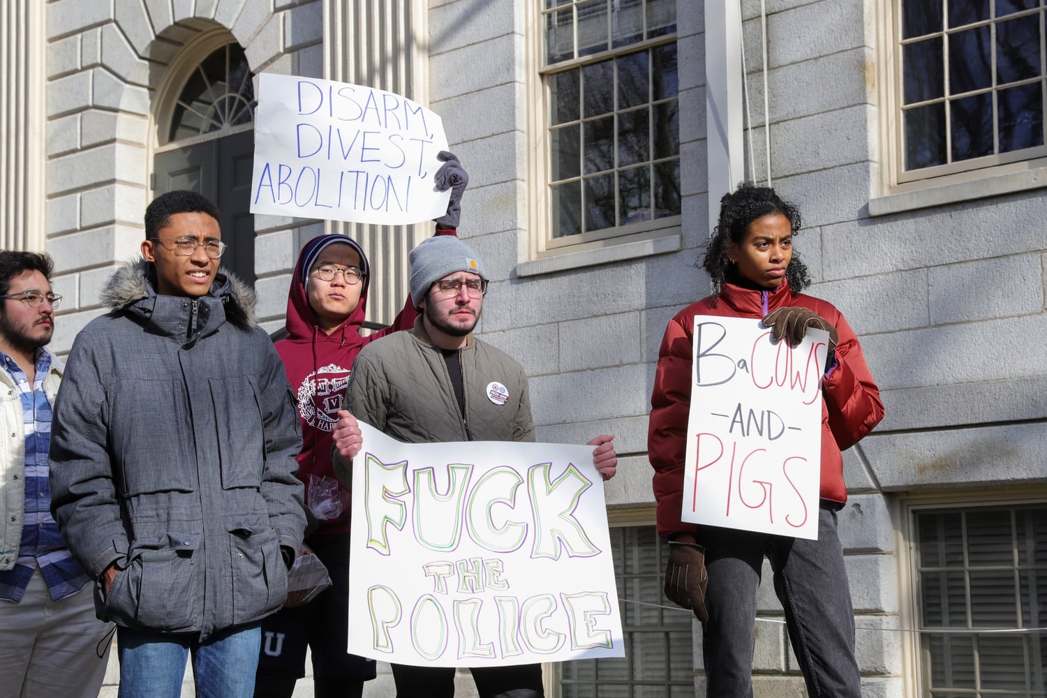 Students brandished signs that read “Abolish HUPD, End Discrimination” and “Policing is Violent" at a Saturday protest calling for HUPD's abolishment.