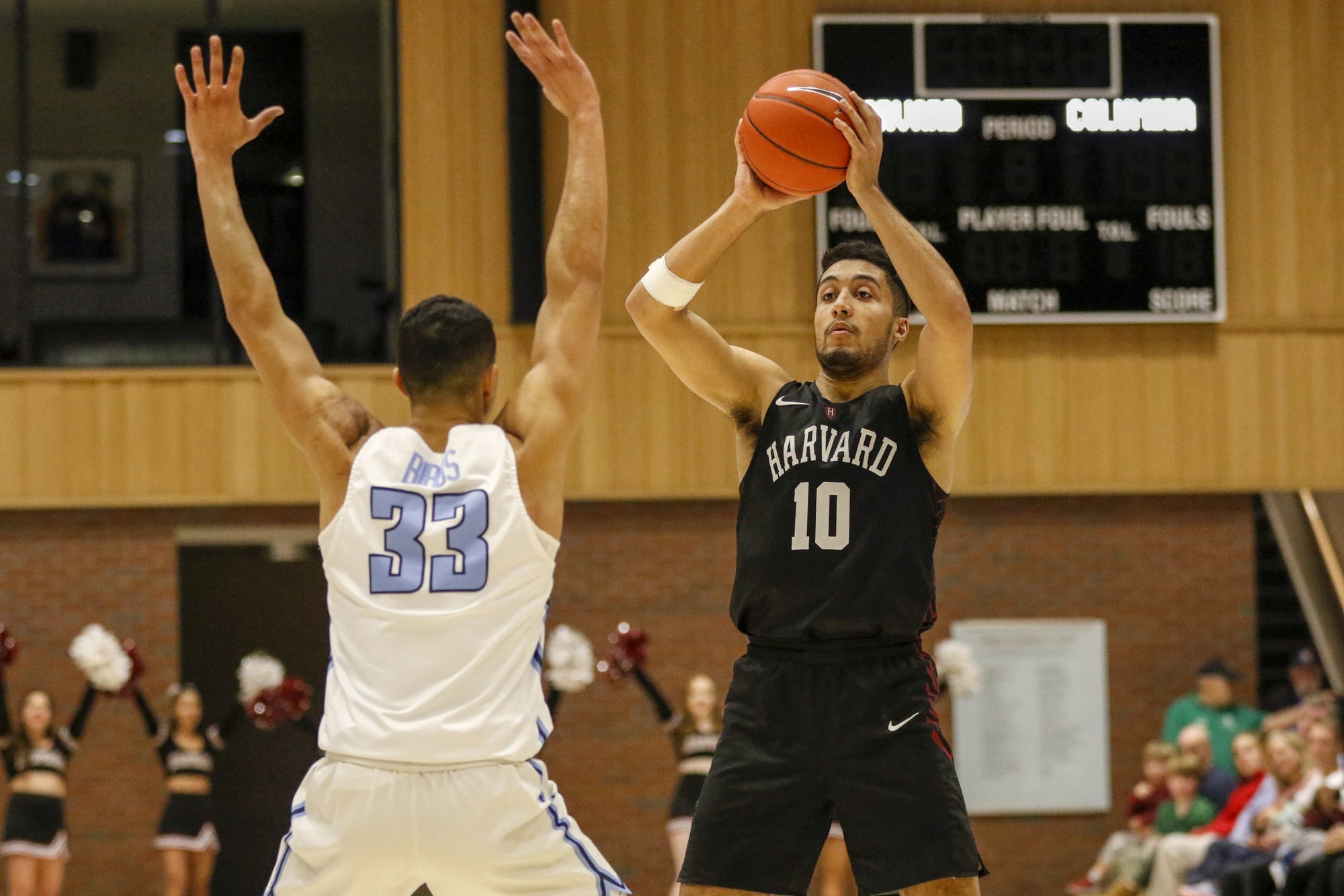 Noah Kirkwood looks to make a play with Columbia's Tai Bibbs guarding him. Kirkwood came up huge in overtime, when he scored 10 of his team-high 22 points in Harvard's win.
