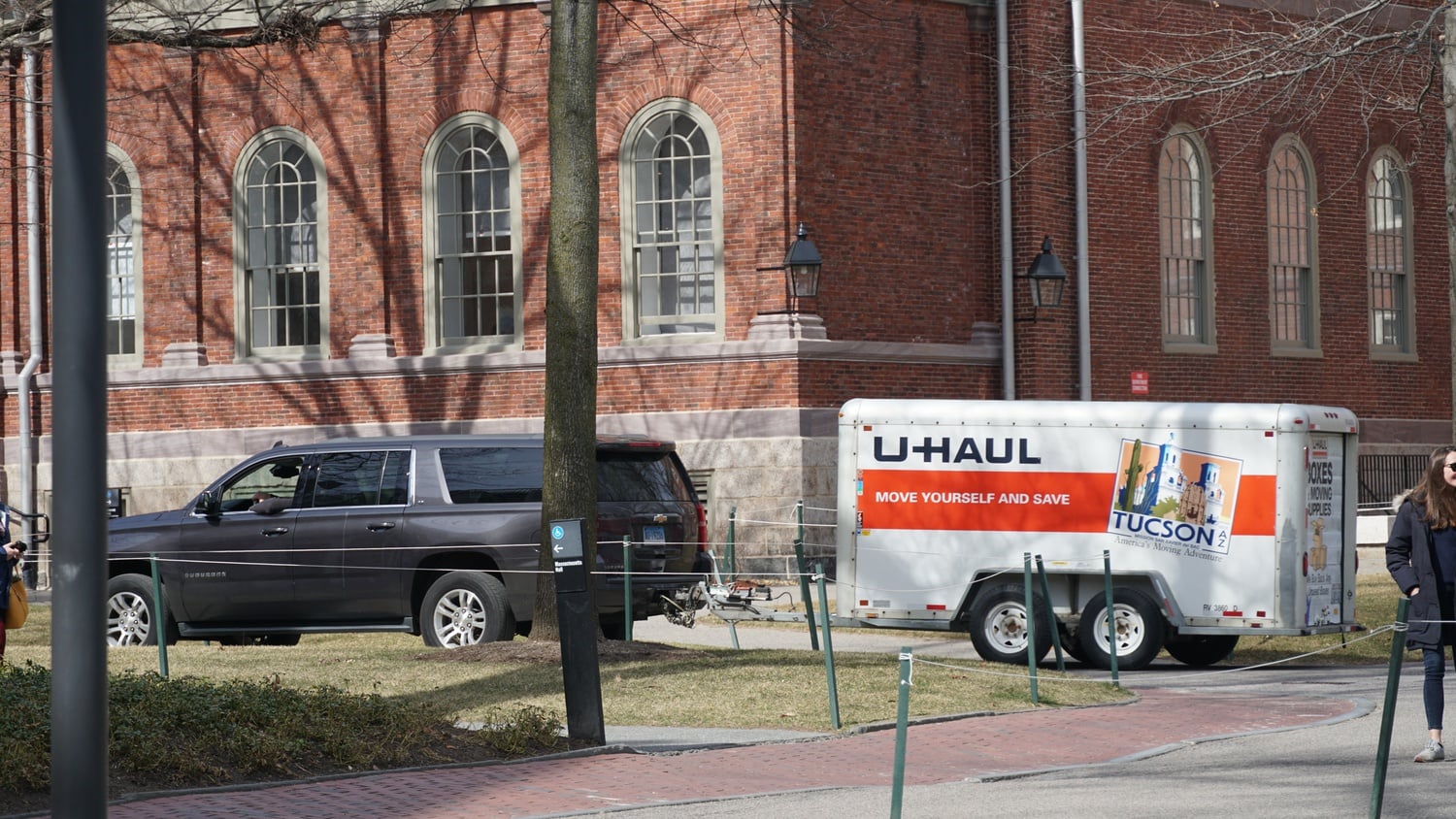 Cars and moving trucks pass through Harvard Yard as students try to make preparations for Sunday's move-out deadline.
