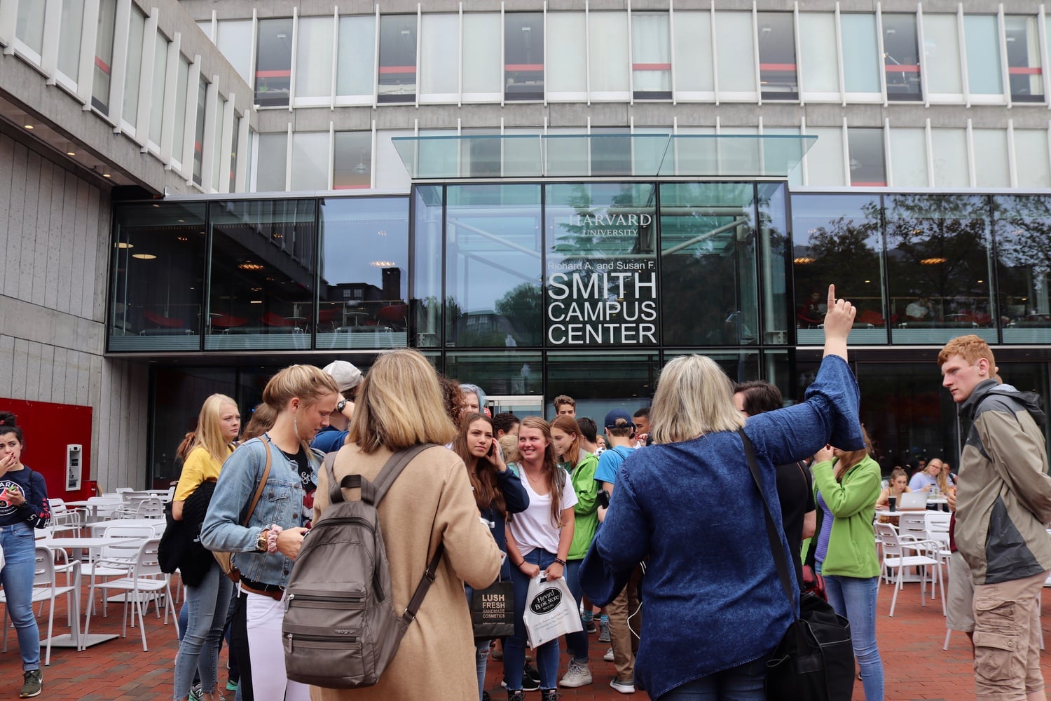 Tourists gather outside the newly renovated Richard A. & Susan F. Smith Campus Center on a warm fall afternoon.