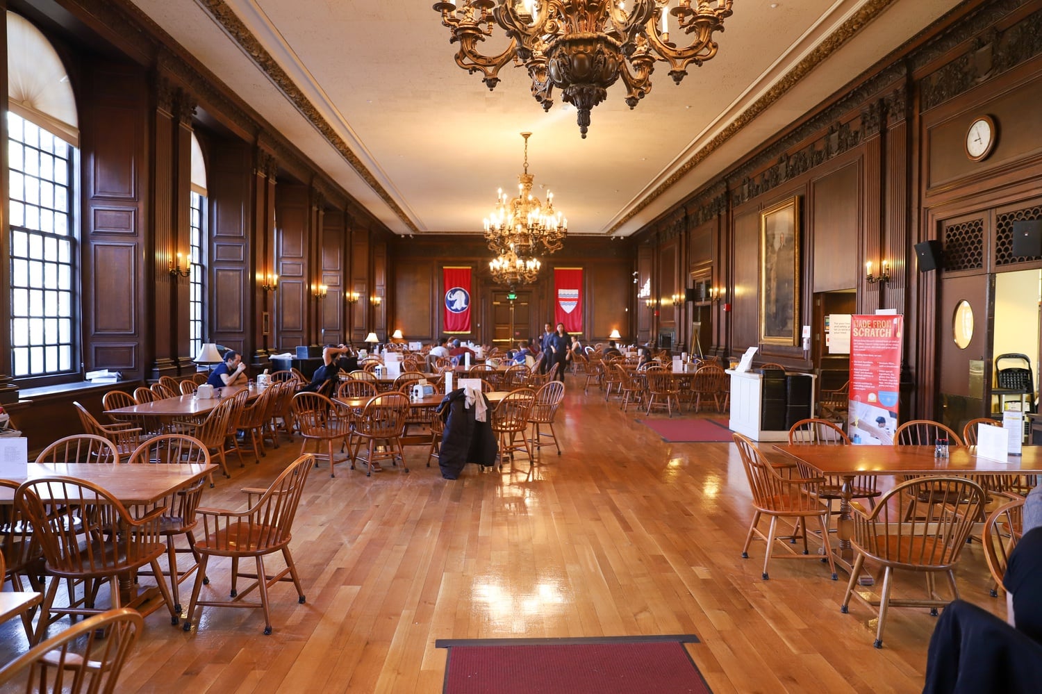Eliot Dining Hall, known for its large windows and beautiful architecture, is mostly empty of students during Sunday morning brunch, depicting the potential implications of social distancing guidelines.