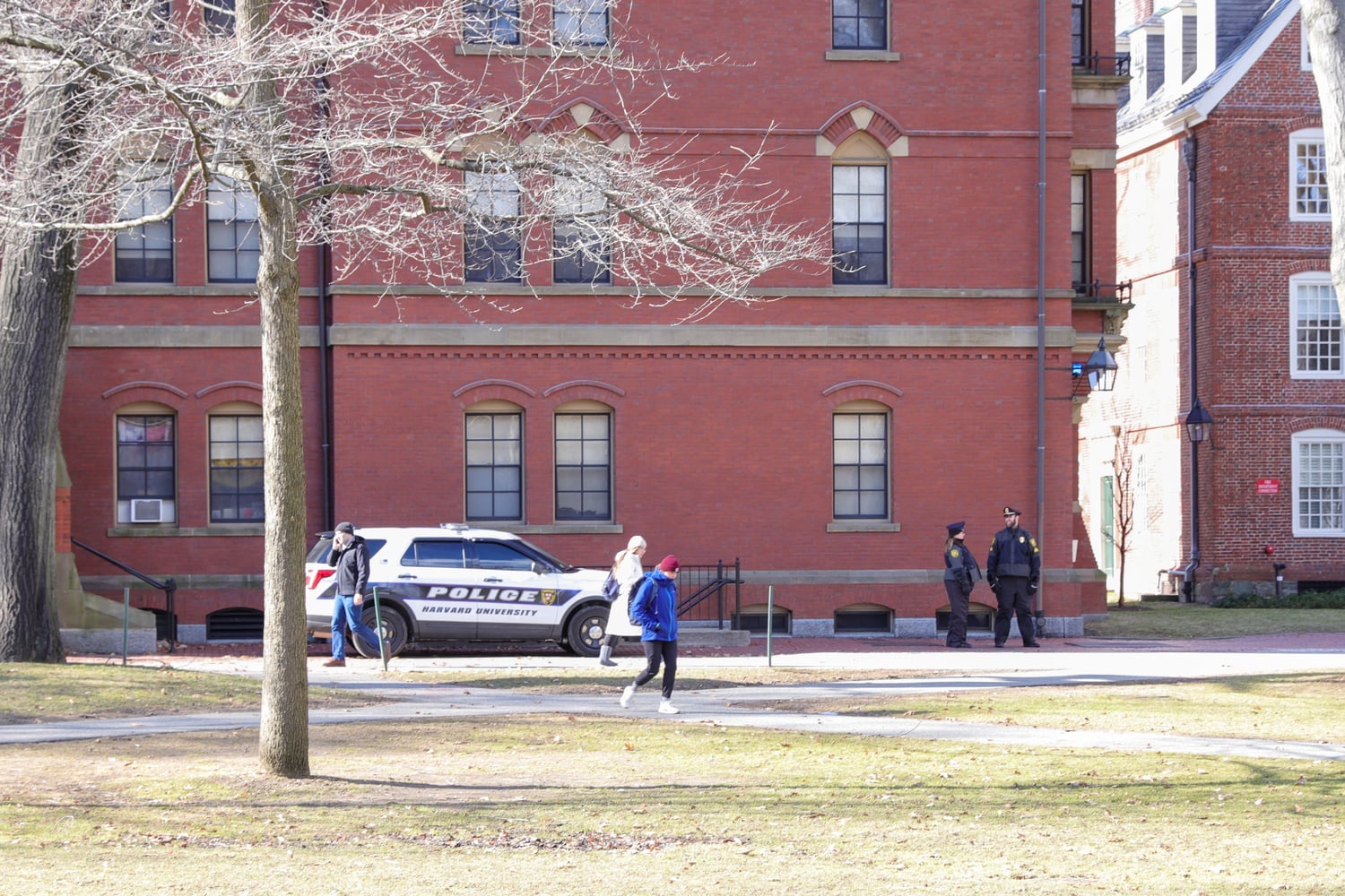 Two Harvard University Police Department officers were involved in a fight in the department's parking lot. Both were suspended, despite one officer's allegation that the other called him racial and homophobic epithets.