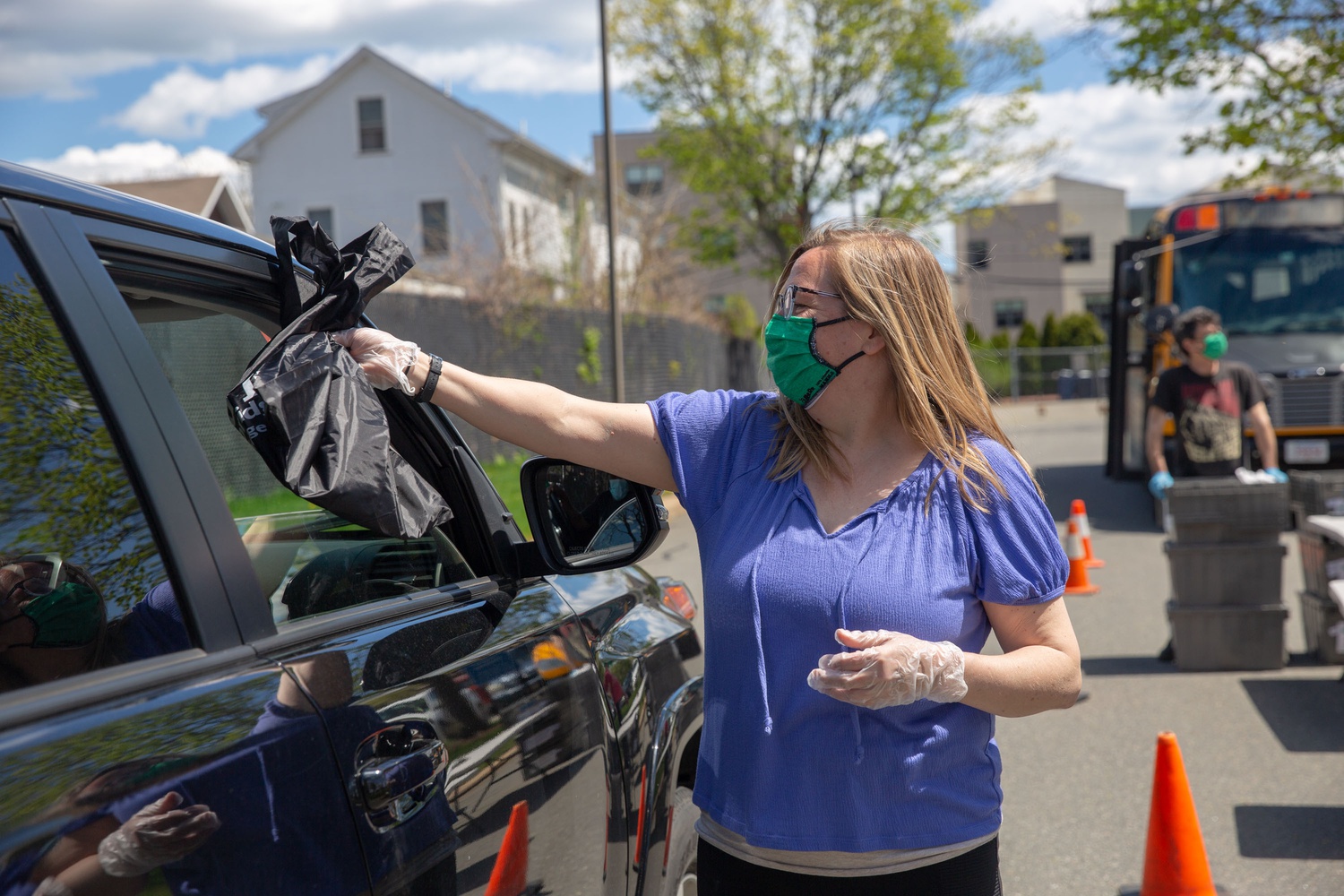 In early May, Nancy Wyse, Family Liaison handed out books and meals at the Rindge Avenue Apartments in Cambridge.