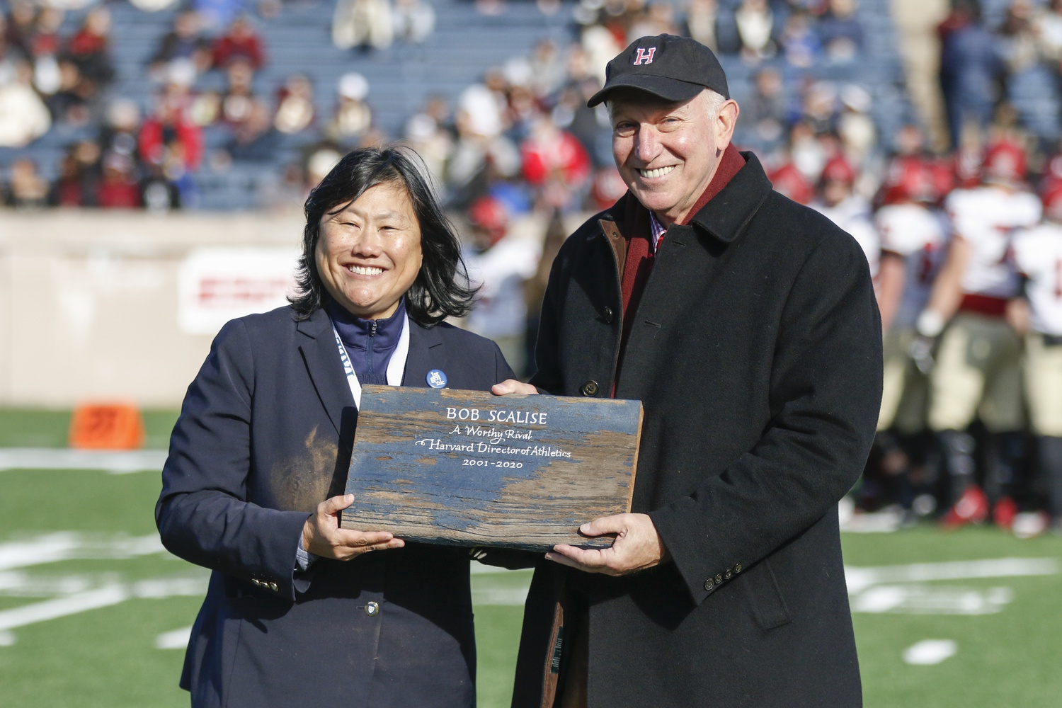 At the 136th rendition of The Game,  Yale's Director of Athletics, Victoria M. Chun, honored her Harvard counterpart, Robert L. Scalise, with a piece of the original Yale Bowl.