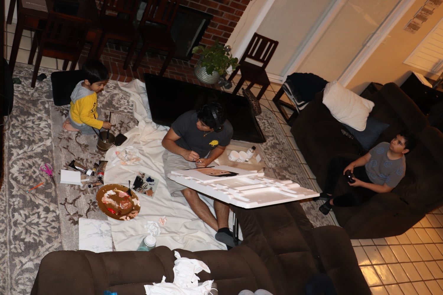 Andrew Pérez works on a painting for a studio art class while at home with his family.