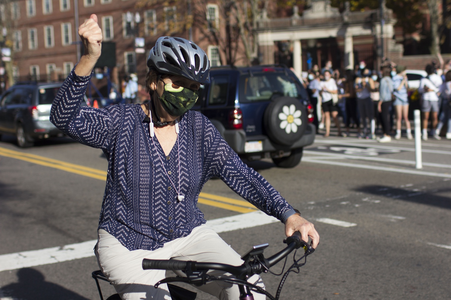 A cyclist raises a fist in celebration on Mass. Ave.