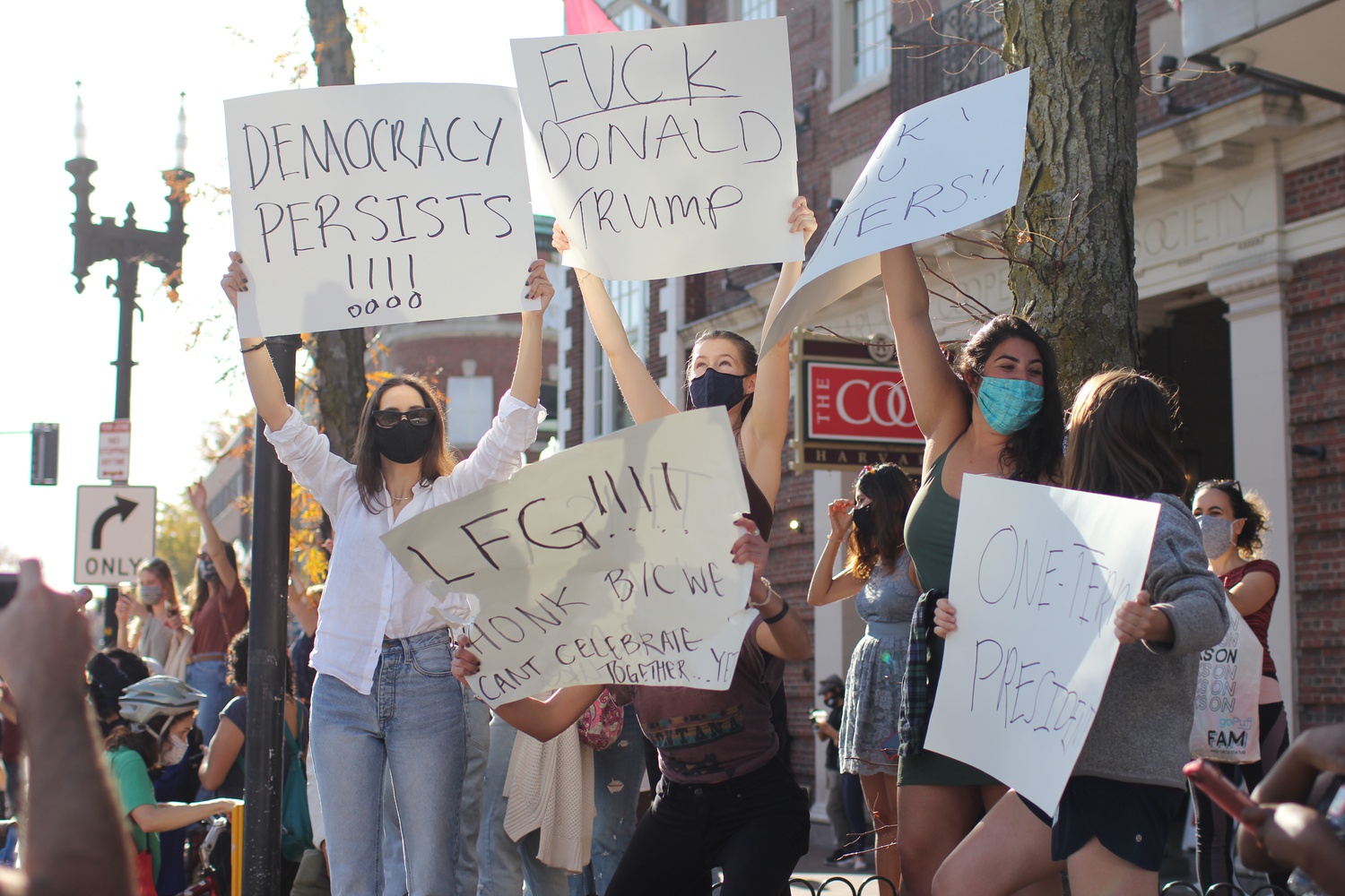 Biden supporters encourage drivers in Harvard Square to honk in celebration of their candidate's victory.