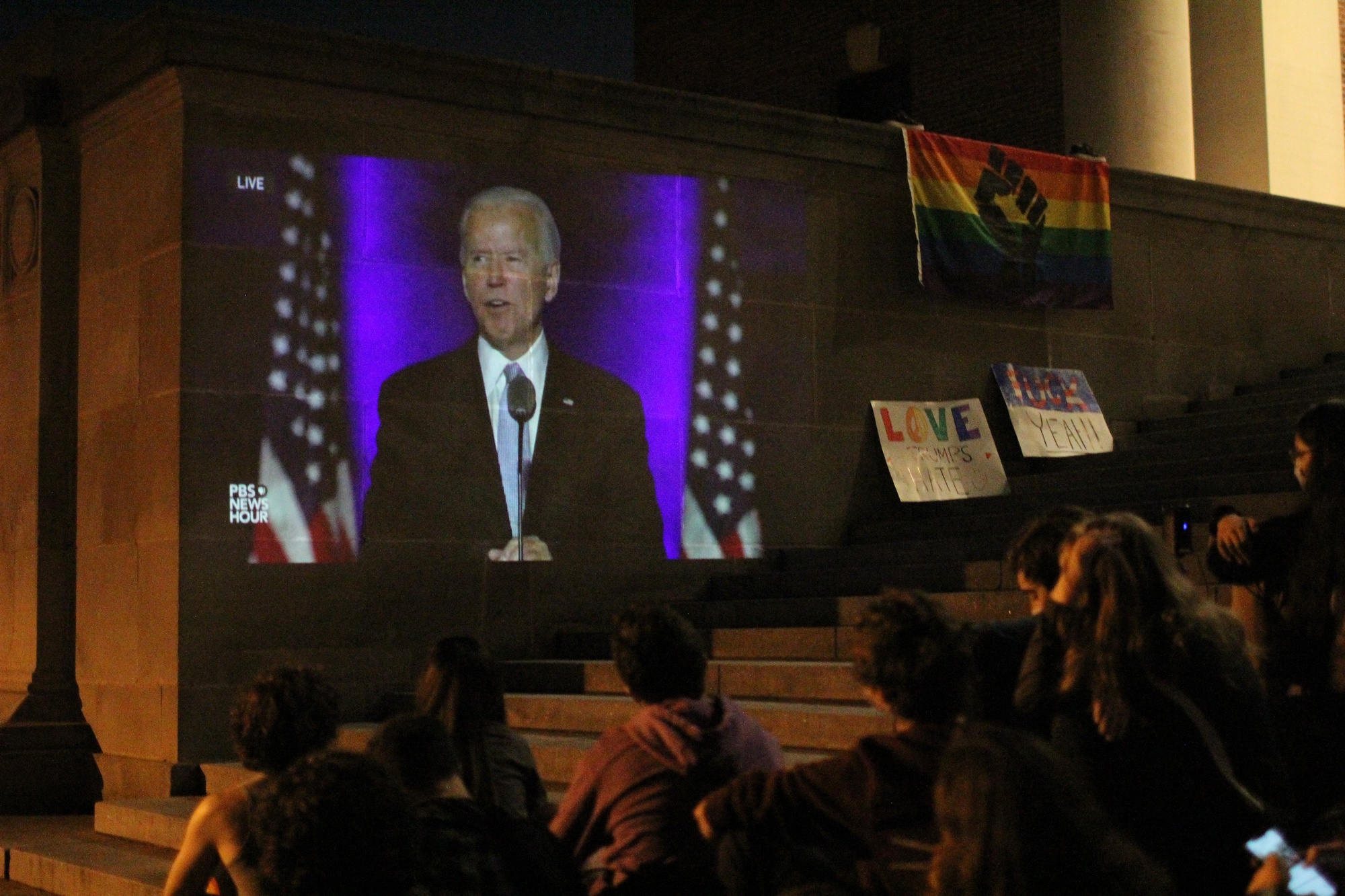 Harvard students living on campus watch former Vice President Joseph R. Biden Jr. deliver his acceptance speech from the steps of Widener Library