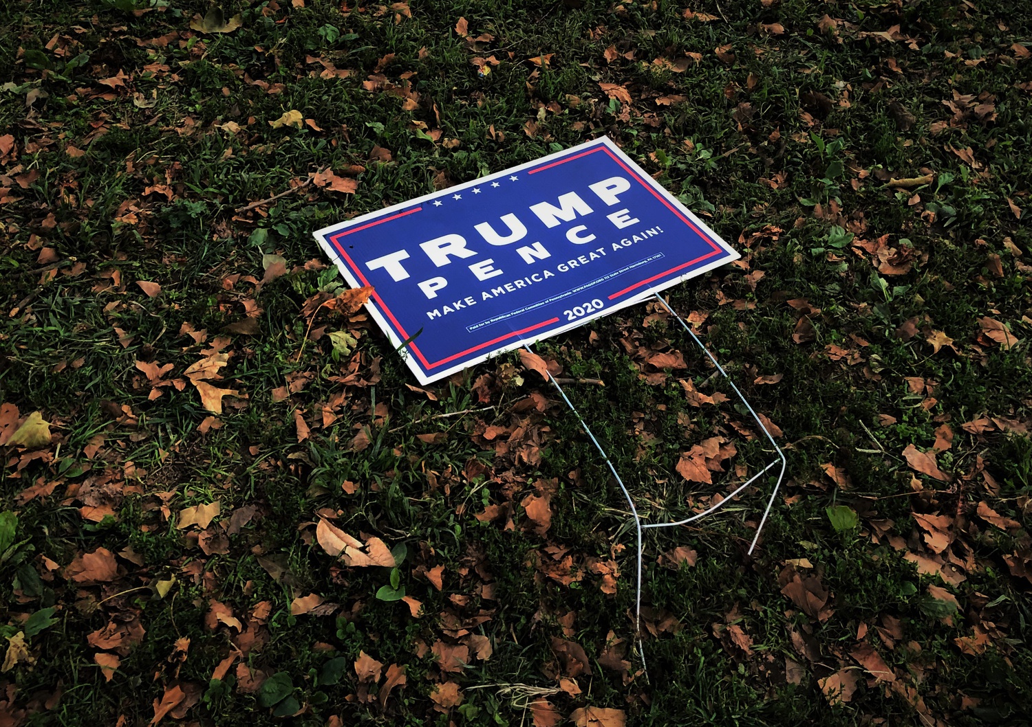 Outside a polling station, a Trump-Pence sign appears to have fallen over.
