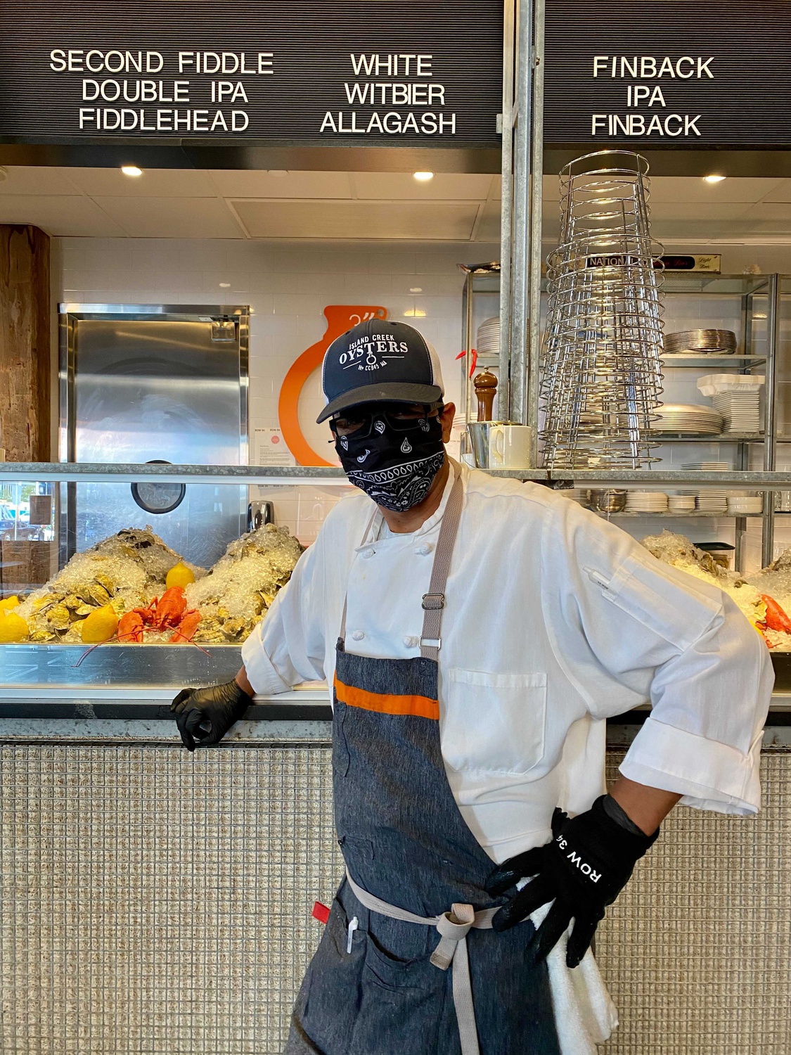A member of the kitchen staff stands at the counter of Row 34, one of two restaurants by award-winning Chef Jeremy Sewall; he opened the ghost restaurant La Ventana recently.