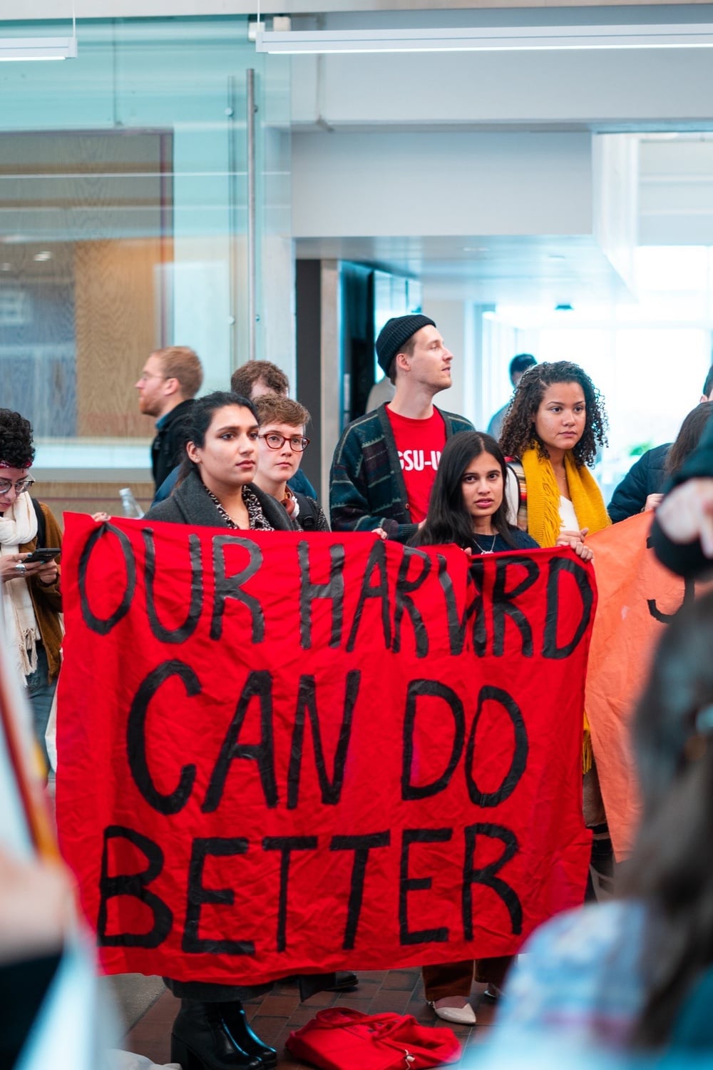 Danu A. Mudannayake '20, a former Crimson editor, Sanika S. Mahajan '21, and Remedy Ryan '21 representing Our Harvard Can Do Better at a protest in 2019.