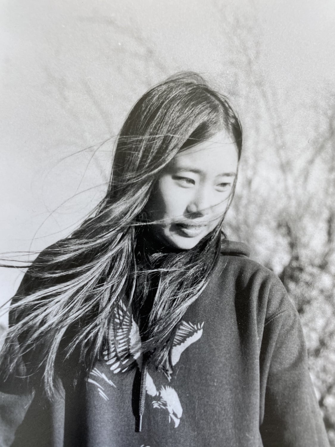 A friend, turning from a gust of wind.