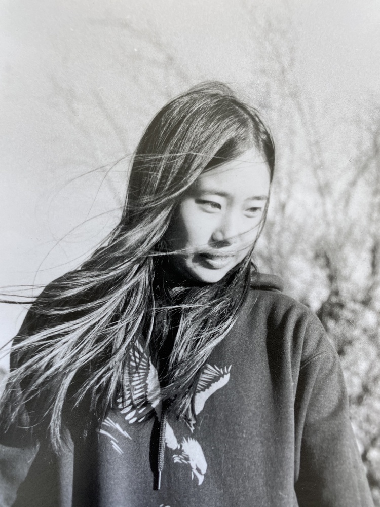 A friend, turning from a gust of wind.