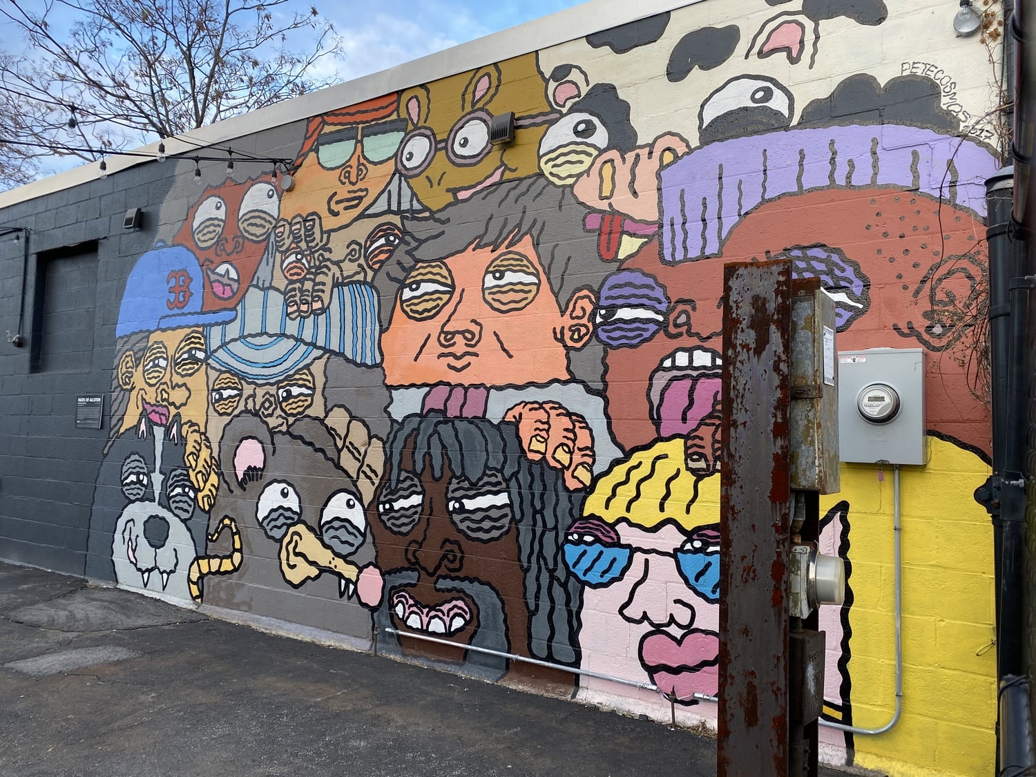 "Faces of Allston" is a mural by artist Pete Cosmos. It is located at 267 Western Avenue in Allston, the center of activity for the Harvard cultural initiative Zone 3.