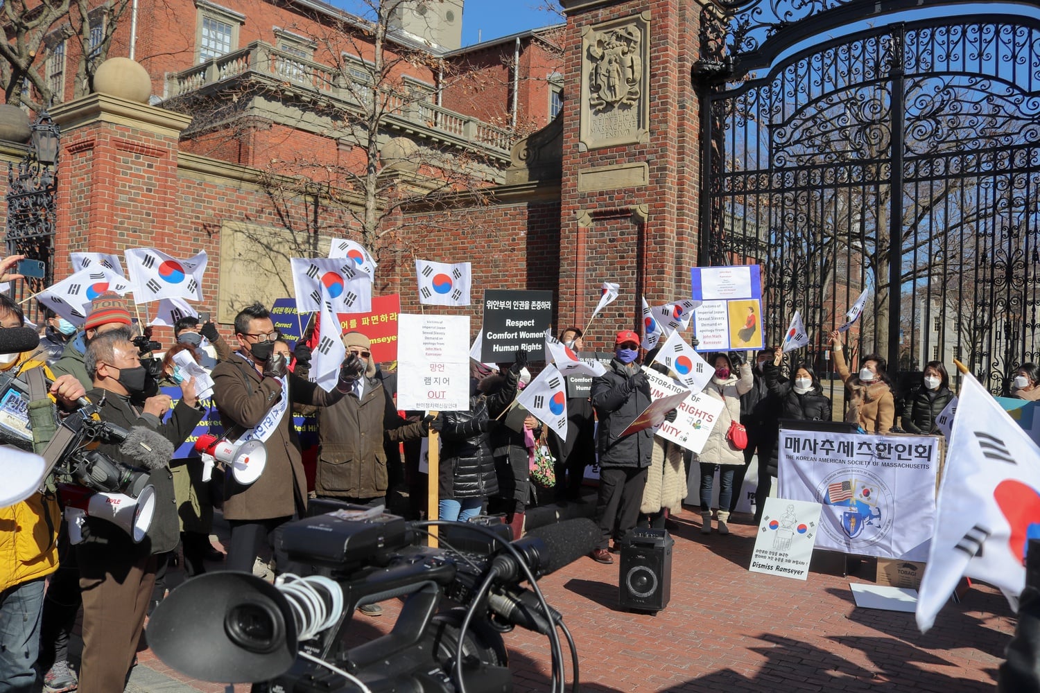 Dozens of demonstrators gathered outside Harvard Yard Saturday to protest Harvard Law professor J. Mark Ramseyer's upcoming paper on comfort women. Ramseyer has faced an outpouring of public criticism from government officials worldwide over the article.