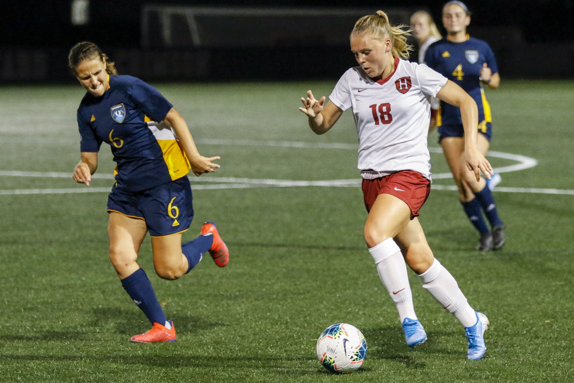 Lara Schenk dribbles past Quinnipiac players on Jordan Field in a contest on Sept. 4, 2019. The Crimson would go on to win the match 3-0.
