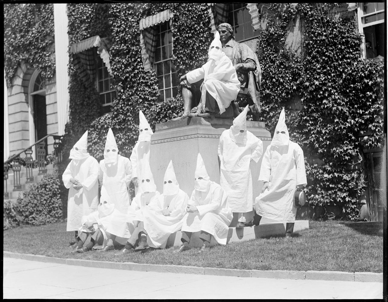 Members of the Harvard branch of the Ku Klux Klan pose for a graduation photo on Class Day 1924 at the foot of the John Harvard Statue in Harvard Yard.