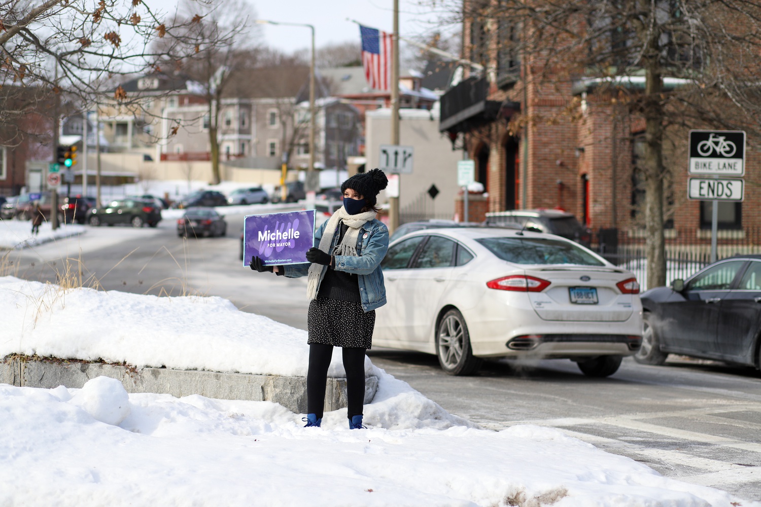 A supporter holds a sign at a standout event in Brighton's Oak Square in February.