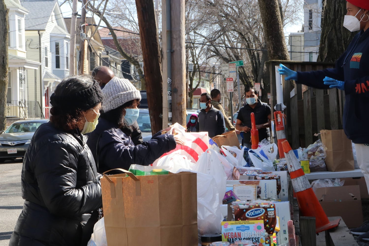 Food distribution takes place outside of the Cambridge Community Center. The Cambridge Community Center created its Food & Supply Pantry in response to the coronavirus pandemic.