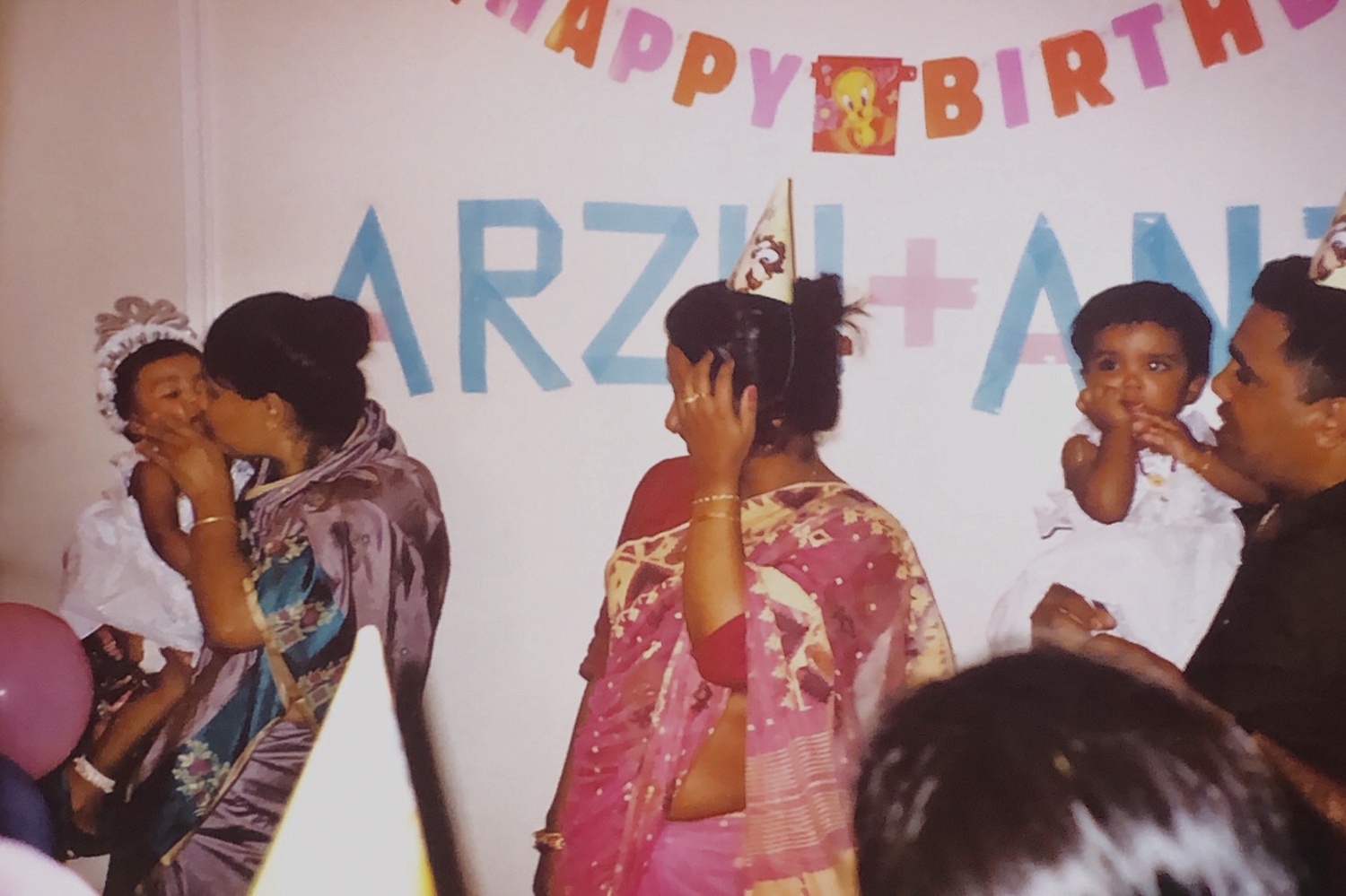 Nanu gives Saima a smooch on her first birthday.