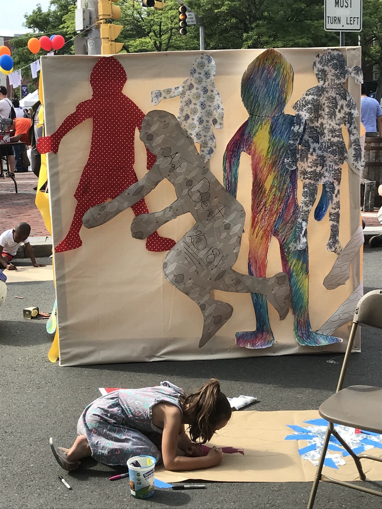 In 2018, Christina M. Tedesco invited members of the Somerville community to make life-sized paper dolls of themselves, collecting them into a temporary mural called "Traces of Bodies."
