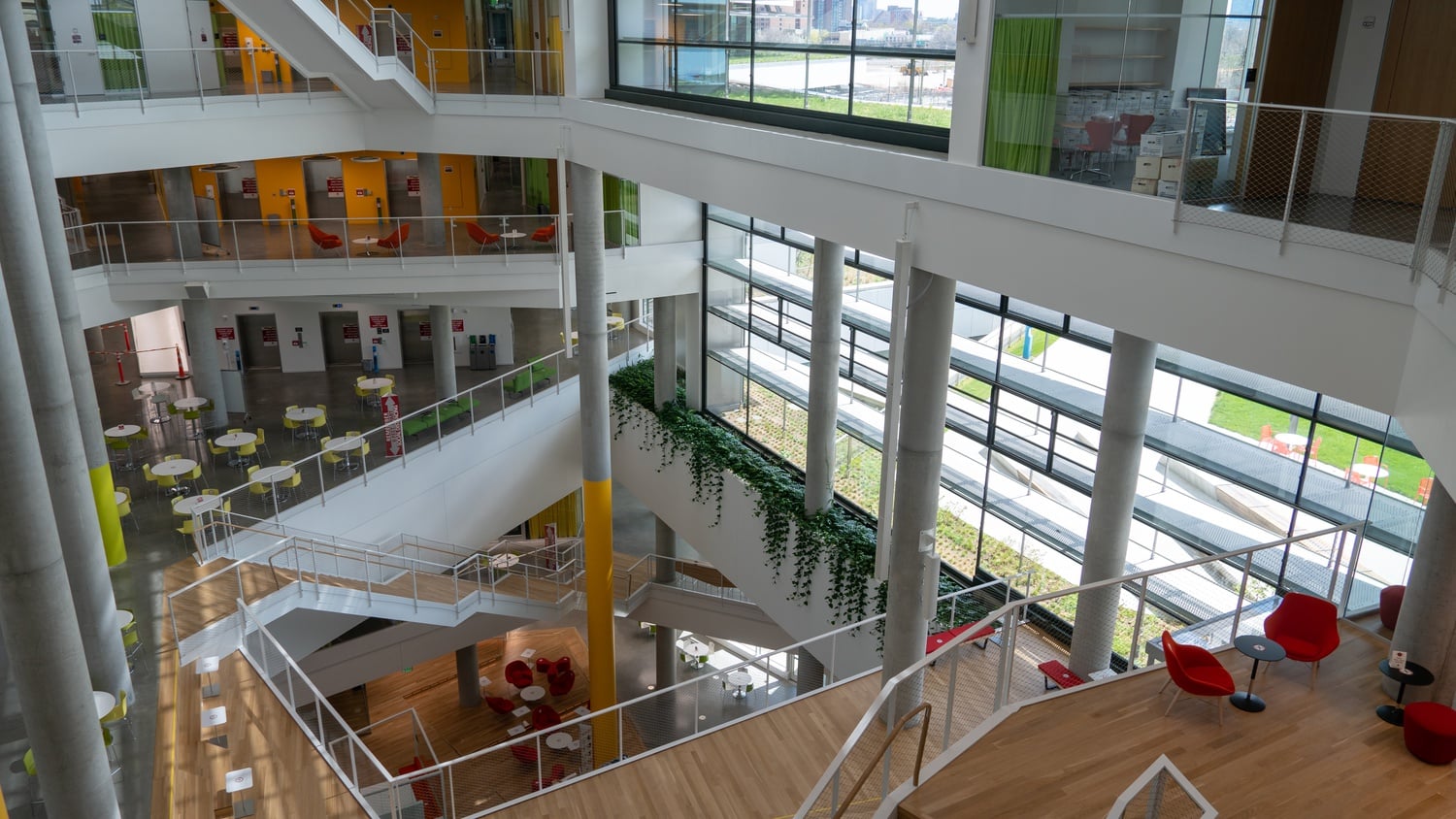 The larger atrium runs six stories up and two stories below ground. It features retractable projector screens for events and large windows which let in natural light.