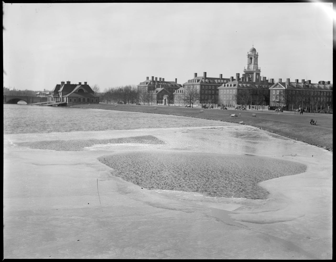 A March 1932 photo of Eliot House taken from Weeks Footbridge with a sandbar in the foreground. Many of the River Houses along the Charles may be susceptible to increased flooding in the next century due to climate change.