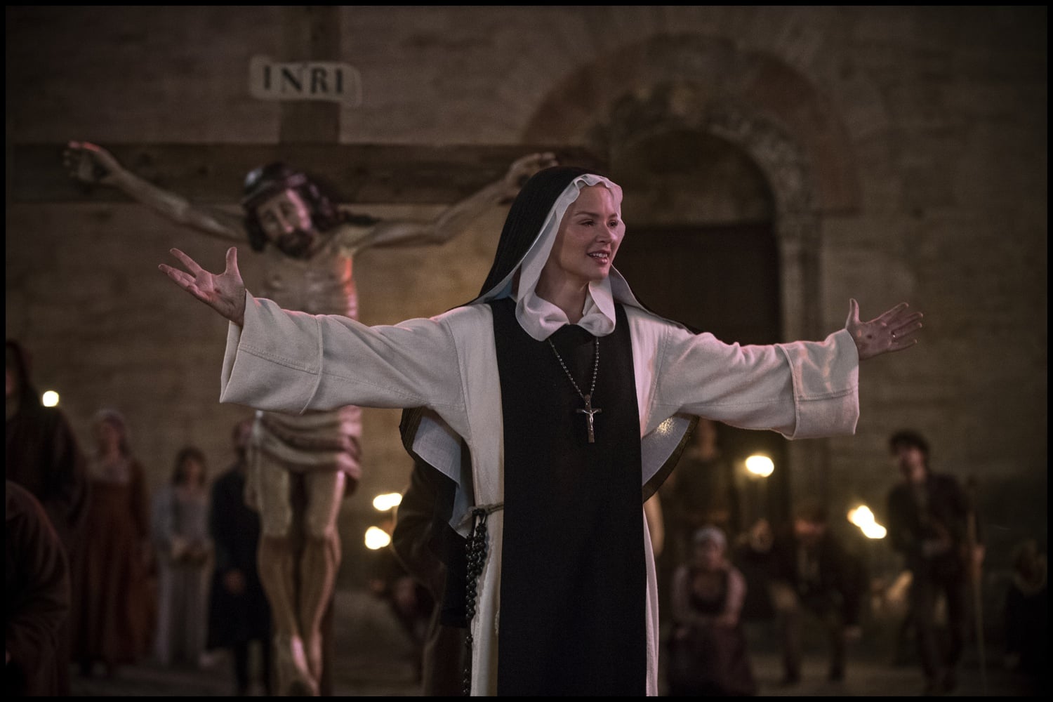 Benedetta (Virginie Efira) in front of a crucifix