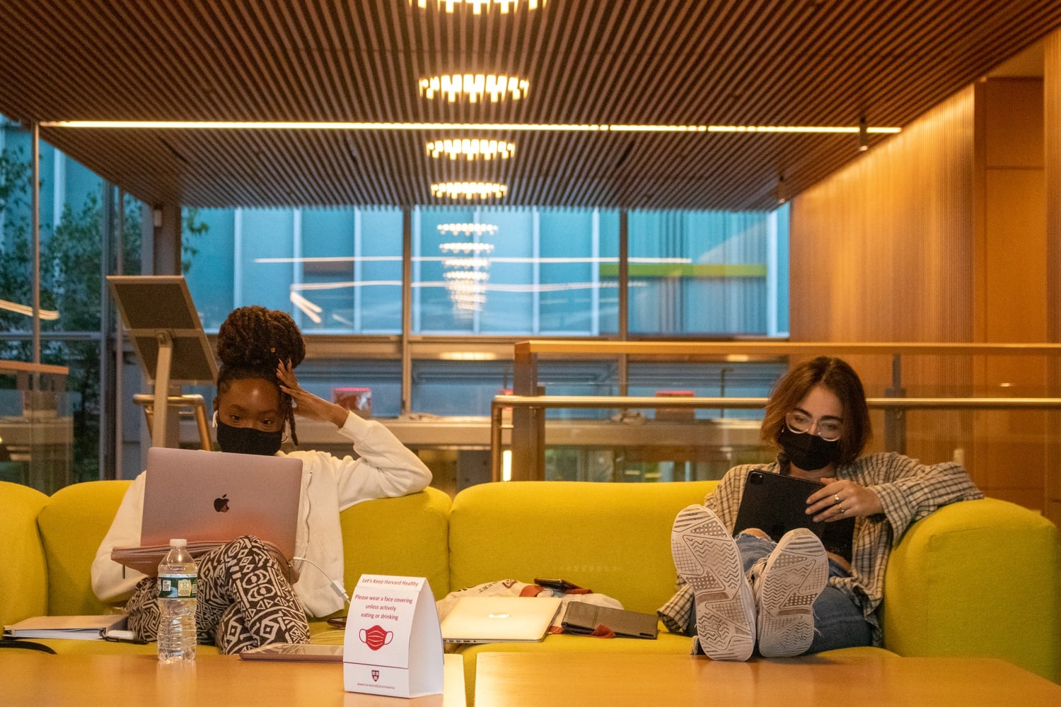 Masked students use laptops at the Smith Campus Center.