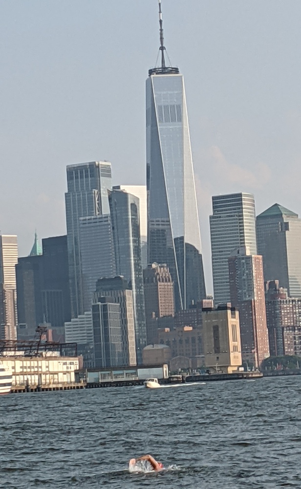 Kaufman does freestyle as the iconic Lower Manhattan skyline, highlighted by One World Trade Center, looms in the background.