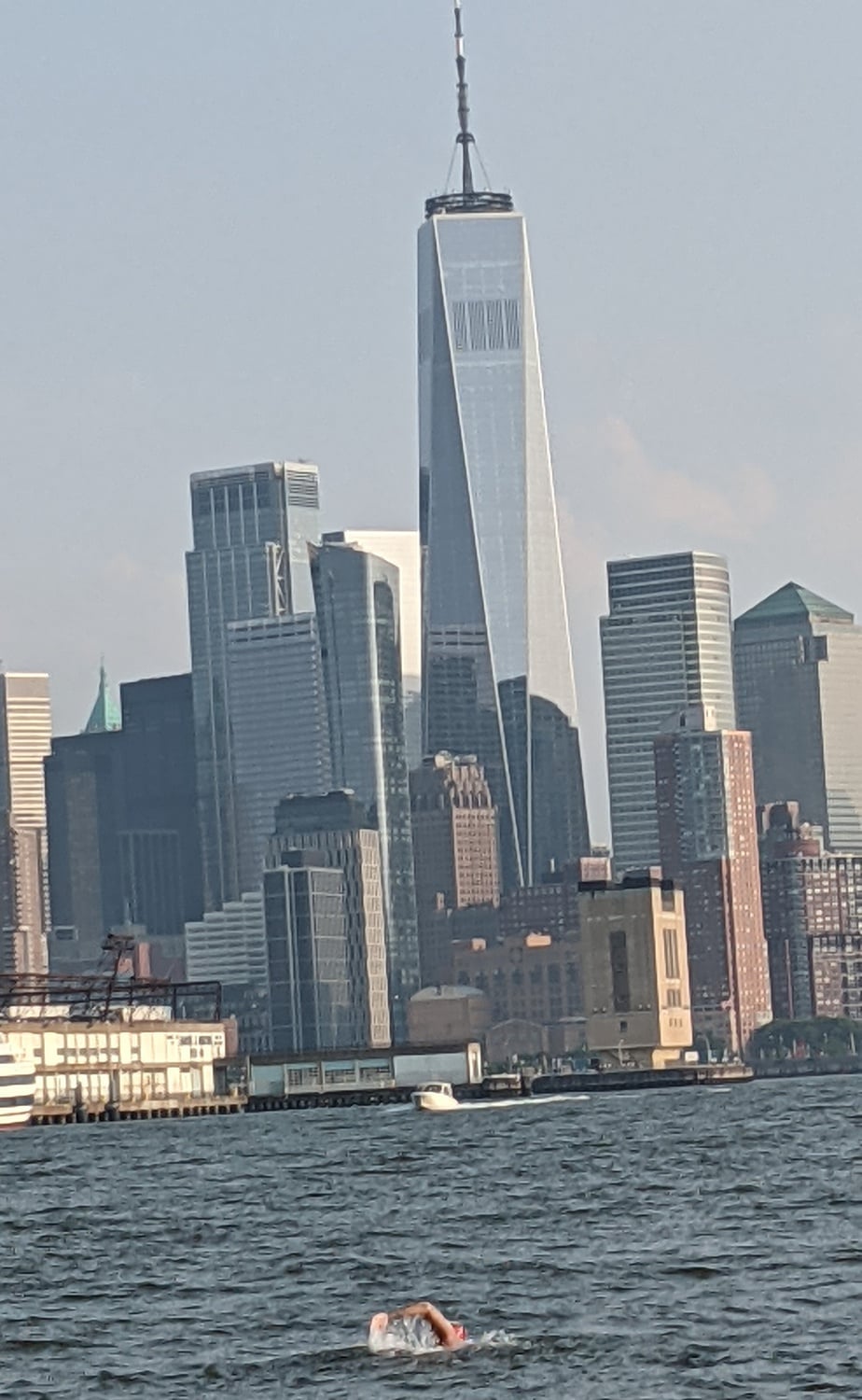 Kaufman does freestyle as the iconic Lower Manhattan skyline, highlighted by One World Trade Center, looms in the background.
