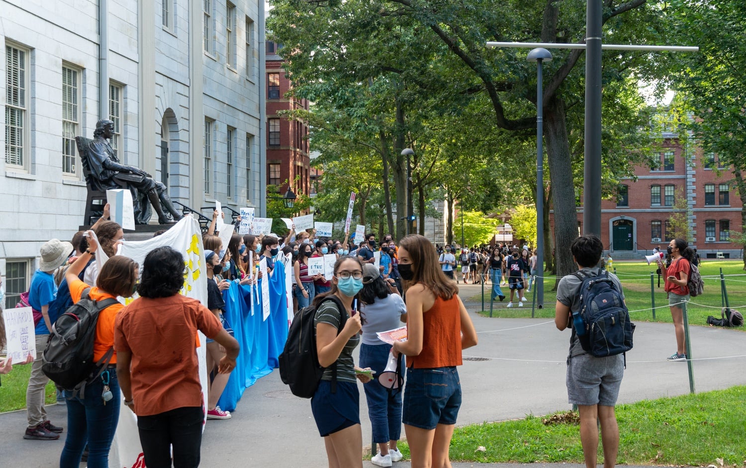 Students gathered for a rally in front of University Hall Tuesday demanding Harvard to divest from fossil fuels.