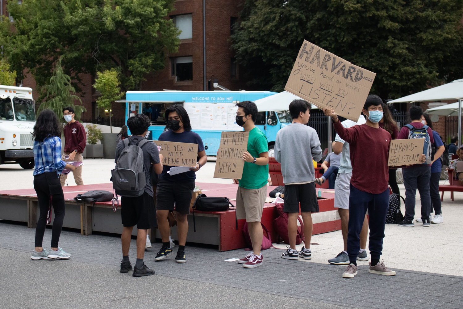 Students hold signs at a rally in support of shopping week on Tuesday.