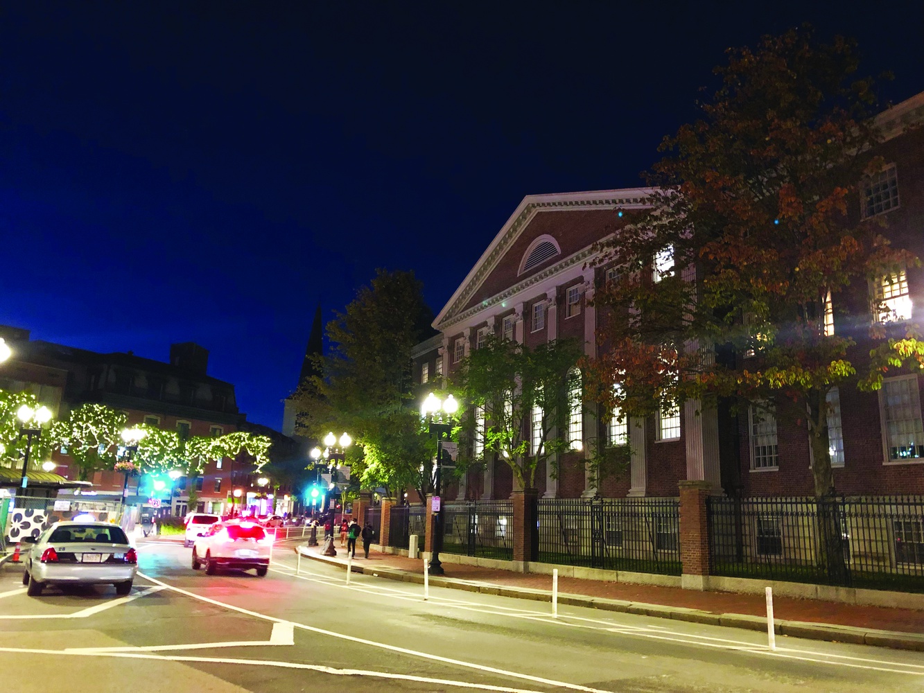 Lehman Hall stands among the businesses of Harvard Square on Monday night. Many students in the Graduate School of Arts and Sciences, centered in Lehman Hall, support the removal of Harvard’s shopping week as their jobs are put in jeopardy.