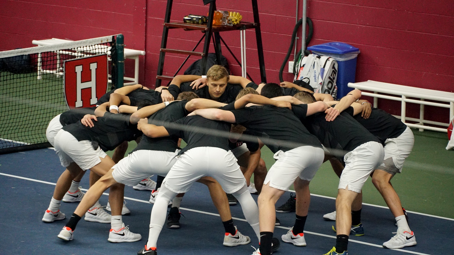 Members of the Harvard men's tennis team, pictured huddling before a February 2020 match, competed in the Intercollegiate Tennis Association's All-American Championships in Tulsa, Okla., beginning Oct. 2.