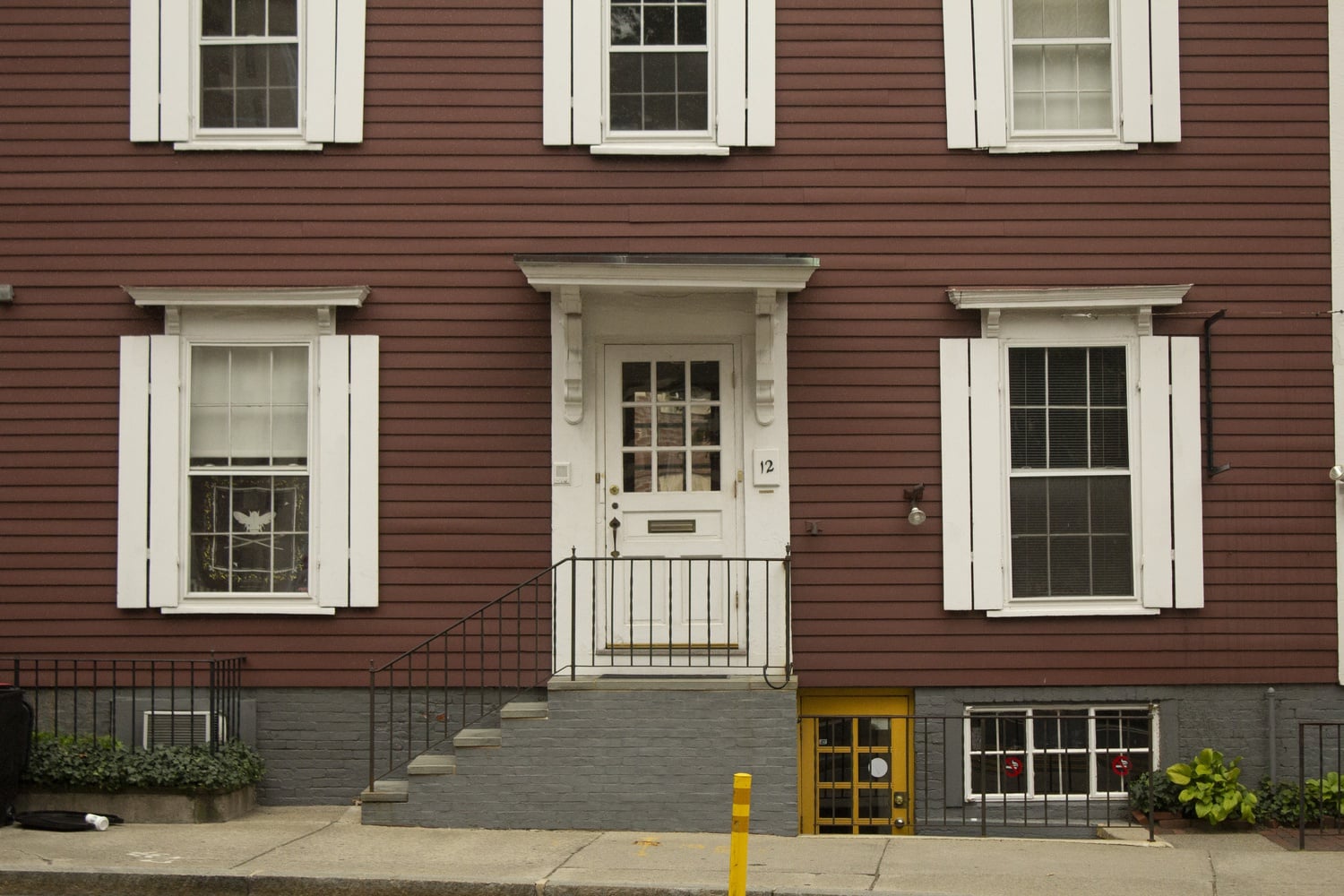 The building at 12 Bow St., formerly home of Café Pamplona, was purchased earlier this year by Susana Vik '22-'23, the president of the Bee Club. A banner with the Bee Club insignia currently adorns one of the first-floor windows.