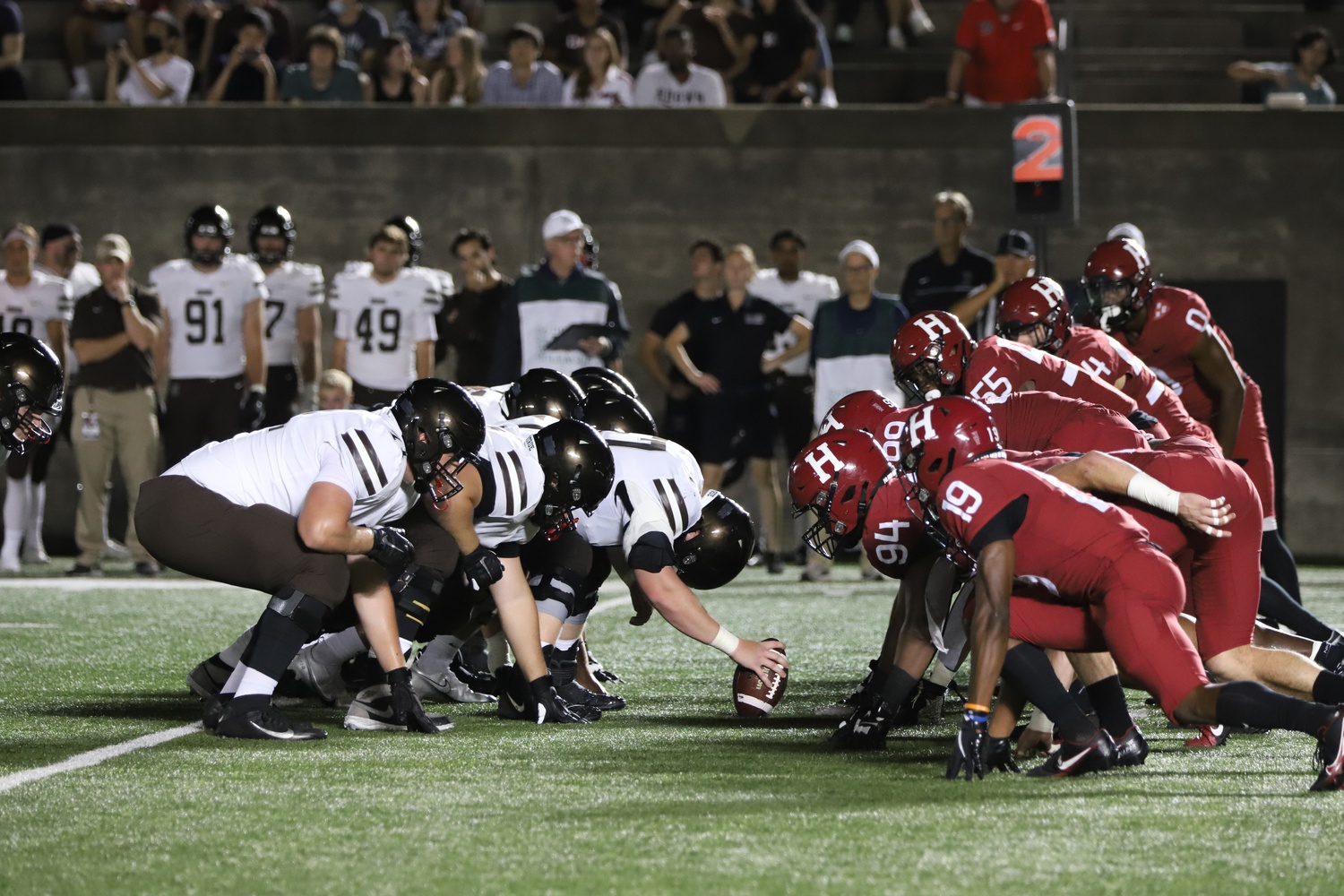 The Crimson and Bears line up for a second-down snap in front of a packed house at Harvard Stadium. The Harvard defense would pitch a shutout in the first half en route to a 49-17 victory.