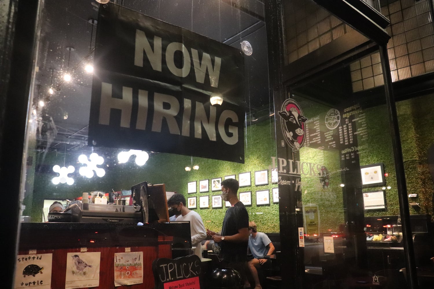 A sign announcing job openings is displayed on the window of J.P. Licks, an ice cream shop in Harvard Square, amid a national shortage of restaurant workers.
