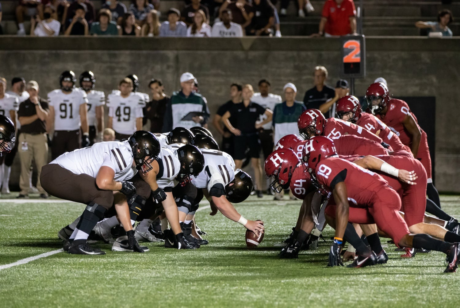 The Harvard defensive line gears up for a snap in the Crimson's 49-17 Ivy League opener win over Brown in September. Line play, whether on defense, offense, or special teams, will likely prove pivotal in Saturday's Harvard-Princeton matchup as both the Tiger and Crimson squads are allowing fewer than 55 yards per game on the ground this season.