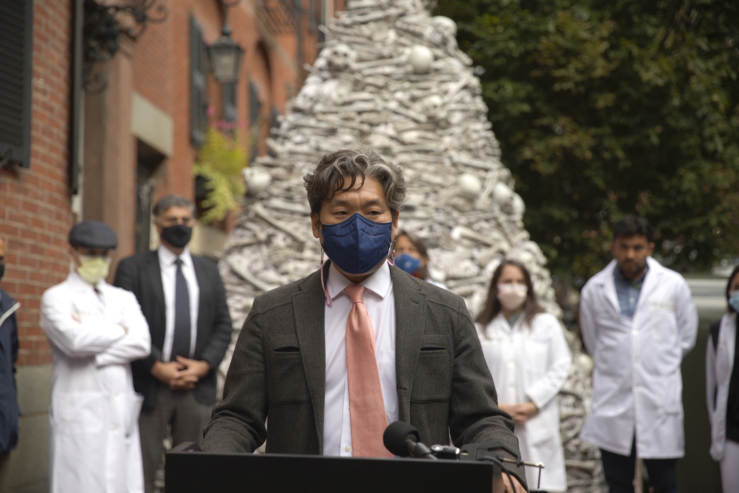 KJ Seung, an assistant professor at Harvard Medical School, speaks at a Wednesday rally during which a group of HMS-affiliated doctors called for global vaccine equity outside the home of Moderna's CEO.