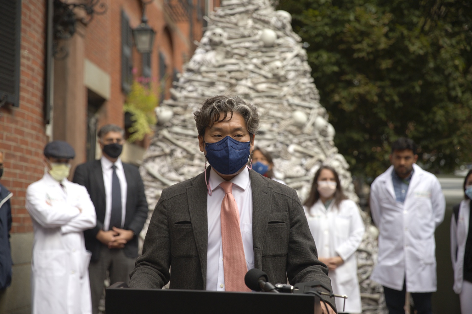 KJ Seung, an assistant professor at Harvard Medical School, speaks at a Wednesday rally during which a group of HMS-affiliated doctors called for global vaccine equity outside the home of Moderna's CEO.