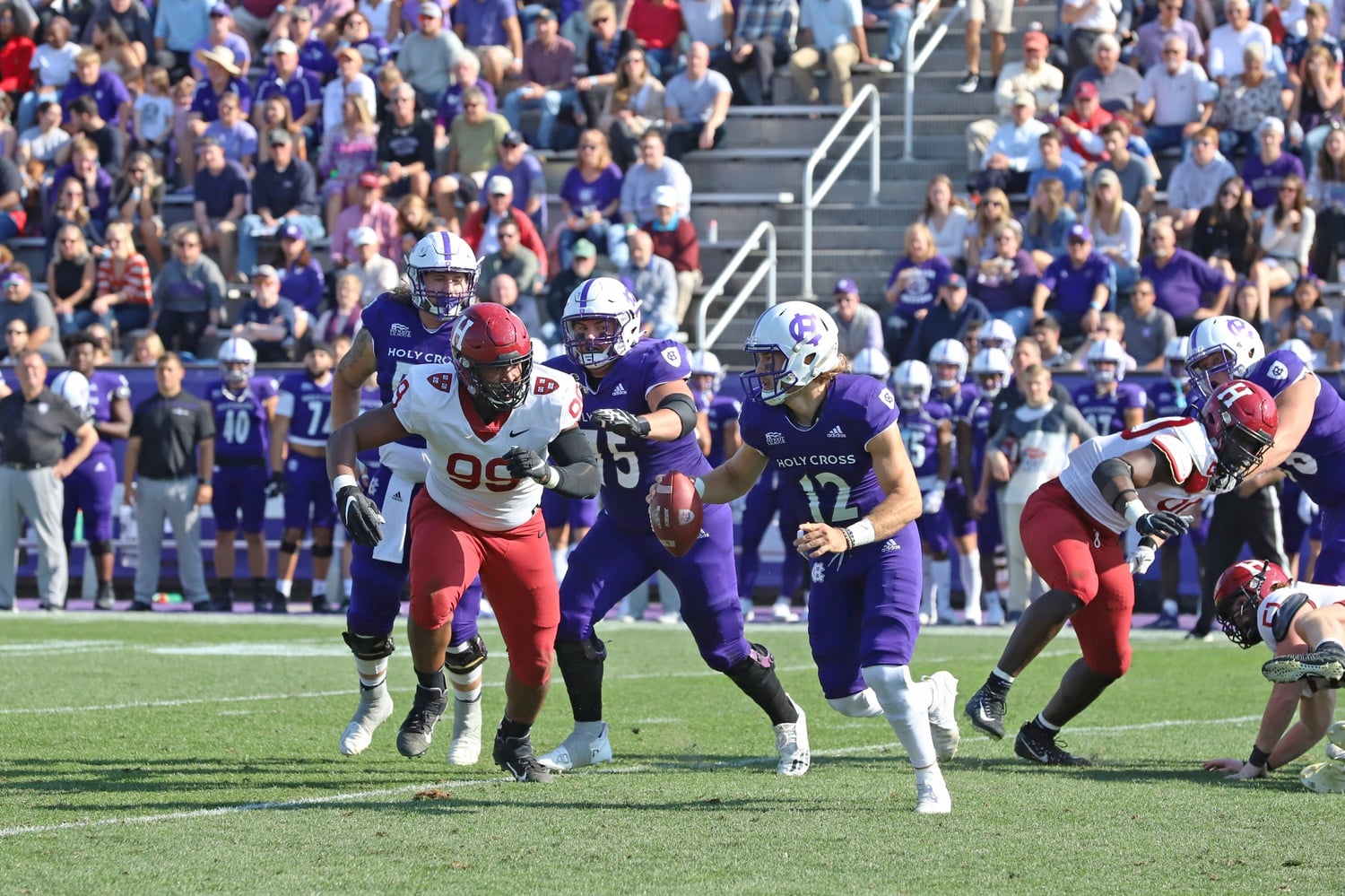 Junior defensive lineman Jacob Sykes pursues Holy Cross sophomore quarterback Marco Siderman. For the third consecutive game, the front seven was a story for the Crimson, contributing to the Harvard defensive effort that saw three sacks, four turnovers, and only 13 points allowed.