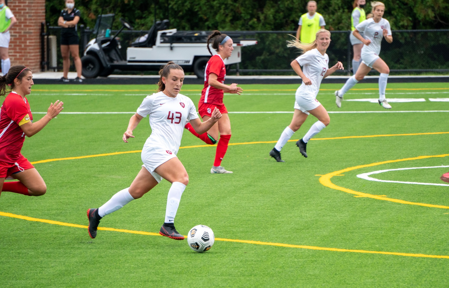 First-year forward Ainsley Ahmadian (#43) dribbles past defenders in a matchup with St. John's as senior forward Murphy Agnew (#12) provides support. Both players are key components in the Crimson's offense but missed the game versus Brown due to injury, dealing a blow to the dynamism of the Harvard attack.