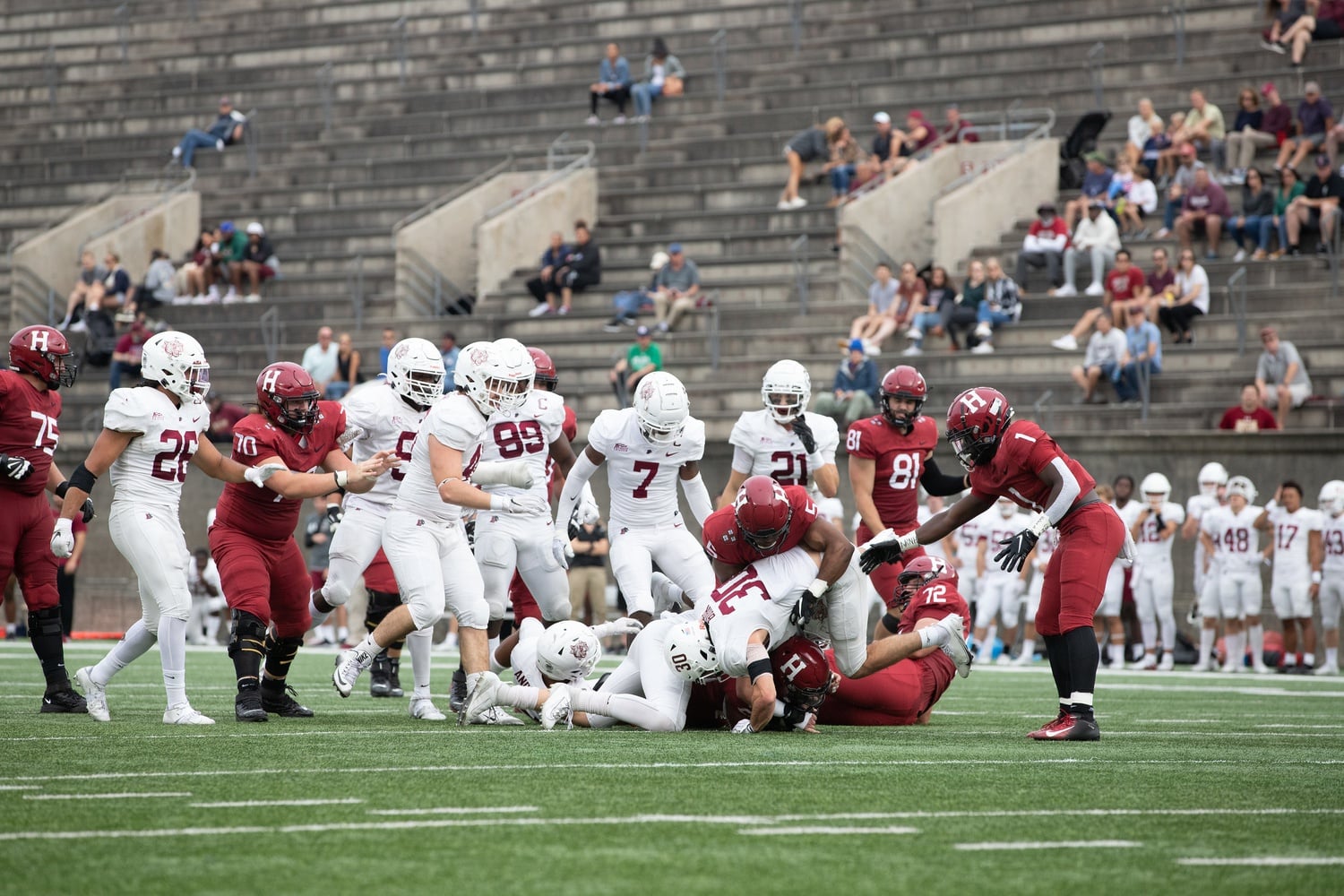 Lafayette aims to knock the ball out while tackling a Harvard player as junior wide reciever Wym Kimberly watches on. Kimberly had one catch for 25 yards on the afternoon.