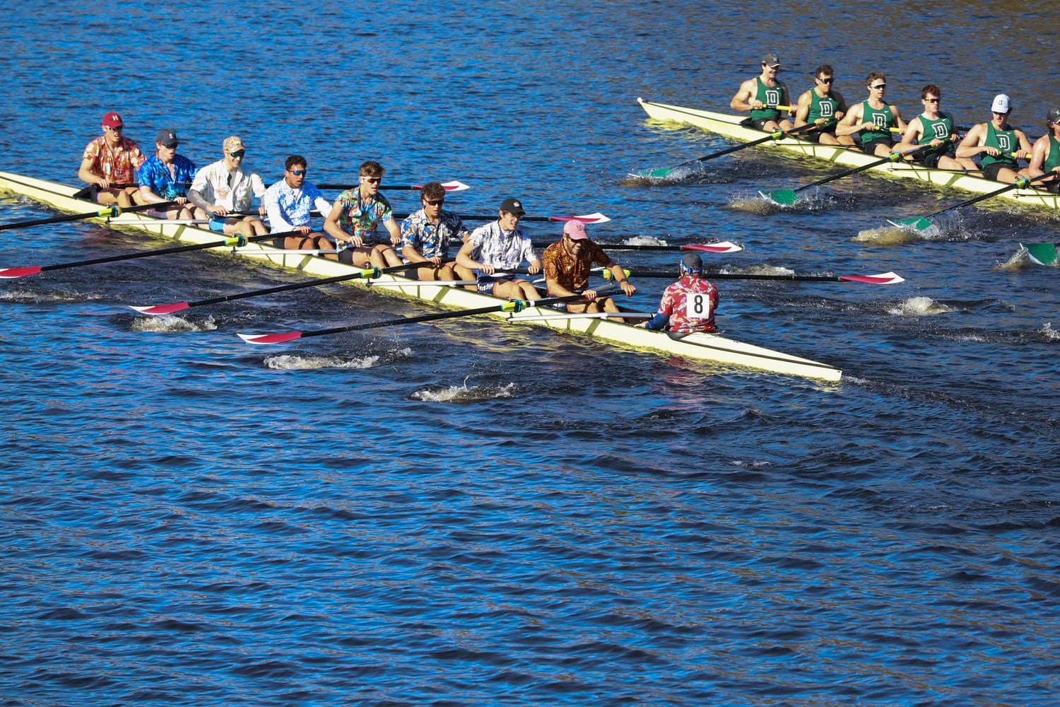 Two boats race each other on the Charles River during the Head of the Charles on Sunday.